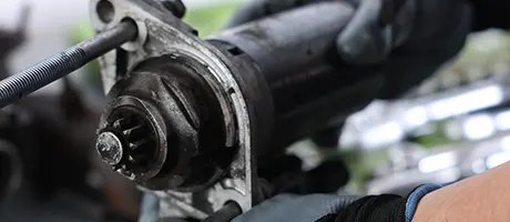 Automotive starter motor in an engine compartment