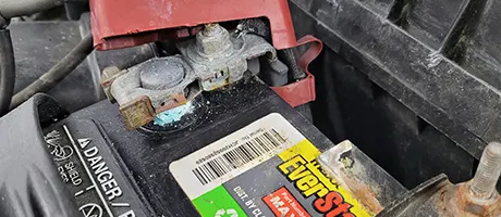 Car battery installed in an engine compartment